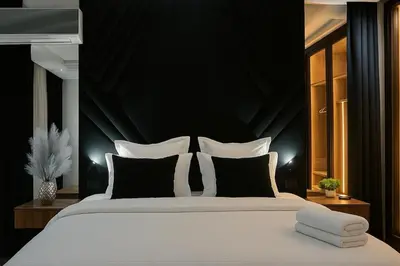 a bedroom with a large bed with a black wall at Luxury, Comfort, Wi-Fi, Hyper Center in Casablanca