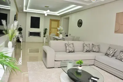 a living room with a white couch and a glass table at Luxury, Comfort, Wi-Fi, Hyper Center in Casablanca