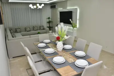 a dining room with a table and chairs and a couch at Luxury, Comfort, Wi-Fi, Hyper Center in Casablanca