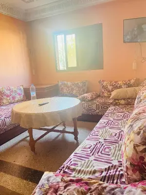 a living room with couches and a table in a room at Msn in Rabat