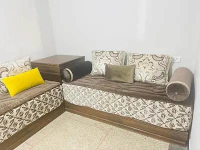a couch with pillows on it in a room at Msn in Rabat
