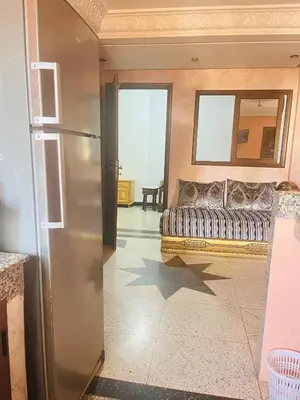 a living room with a couch and a refrigerator at Msn in Rabat