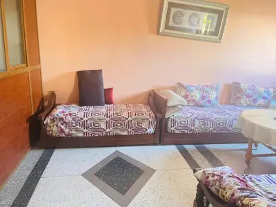 a living room with a couch and a table at Msn in Rabat