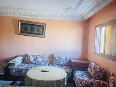 a living room with a couch and a table at Msn in Rabat