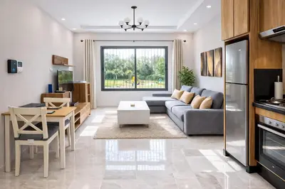 a living room with a couch and a table at Affordable Luxury Apartment in Nouaseur