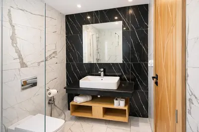 a bathroom with a sink and a mirror at Affordable Luxury Apartment in Nouaseur