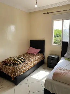 a bedroom with a bed with a leopard print mattress at Cozy apartment in Mohammedia in Mohammedia