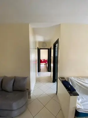 a living room with a couch and a clock on the wall at Cozy apartment in Mohammedia in Mohammedia