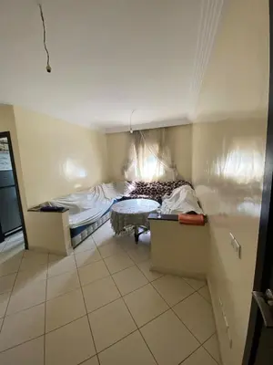 a small room with a bed and a table at Cozy apartment in Mohammedia in Mohammedia