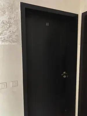 a black door with a handle in a room at Cozy apartment in Mohammedia in Mohammedia