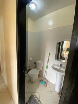 a bathroom with a toilet and a sink at Cozy apartment in Mohammedia in Mohammedia
