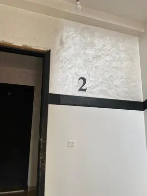 a door with the number on the wall at Cozy apartment in Mohammedia in Mohammedia