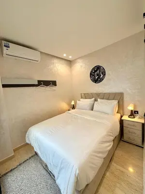 a bedroom with a large white bed in a room at App Chic & Jacuzzi à Bourgogne près de la Corniche in Casablanca-Port