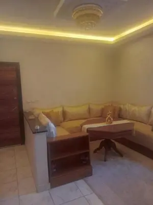 a living room with a couch and a table at Appartement moderne et confortable proche plages in Casablanca