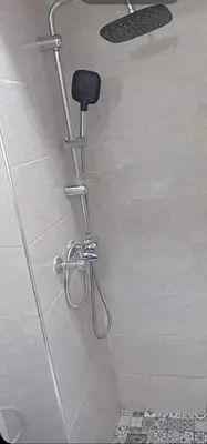 a shower with a black seat in a bathroom at Appartement moderne et confortable proche plages in Casablanca