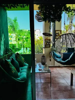 a living room with a couch and swing chairs at High Standing Duplex - Pool Sun in Mohammedia