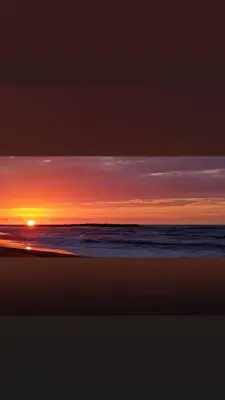 a sunset on a beach with the ocean at High Standing Duplex - Pool Sun in Mohammedia