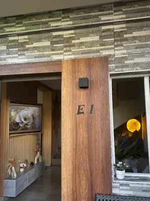 a wooden door with the letter e on a building at High Standing Duplex - Pool Sun in Mohammedia