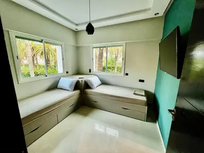a small room with two benches and two windows at High Standing Duplex - Pool Sun in Mohammedia