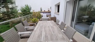 a wooden table and chairs on a balcony at Kridarek - Charming apartment with pool in Tamaris in Tamaris