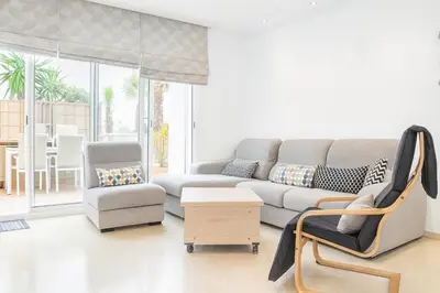 a living room with a couch and a chair at Kridarek - Charming apartment with pool in Tamaris in Tamaris
