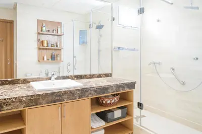 a bathroom with a sink and a shower at Kridarek - Charming apartment with pool in Tamaris in Tamaris