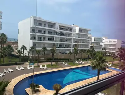 a large apartment building with a large swimming pool at Kridarek - Charming apartment with pool in Tamaris in Tamaris