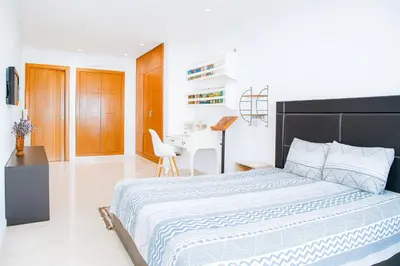 a bedroom with a large bed and a desk at Kridarek - Charming apartment with pool in Tamaris in Tamaris