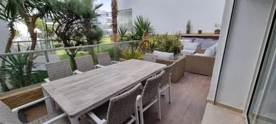 a wooden table and chairs on a balcony at Kridarek - Charming apartment with pool in Tamaris in Tamaris