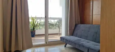 a living room with a blue couch in front of a window at Kridarek - Charming apartment with pool in Tamaris in Tamaris