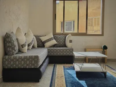 a living room with a couch and a coffee table at Appartement arome in Rabat