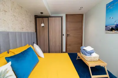 a bedroom with a yellow and blue bed and a table at Elegant Studio - Quiet & Stylish in Casablanca