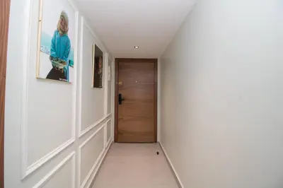 a hallway with white walls and a wooden door at Elegant Studio - Quiet & Stylish in Casablanca