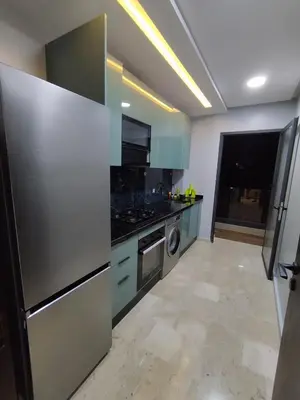 a kitchen with a stainless steel refrigerator and a dishwasher at Rosa Luxury Apartment , Confort, Vue Dégagée , Parking Privé près du CFC in Casablanca