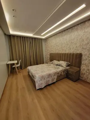 a bedroom with a bed and a desk in it at Rosa Luxury Apartment , Confort, Vue Dégagée , Parking Privé près du CFC in Casablanca