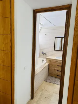 a bathroom with a tub and a sink and a mirror at Atlantica in Rabat