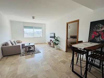 a living room with a couch and a table at Atlantica in Rabat