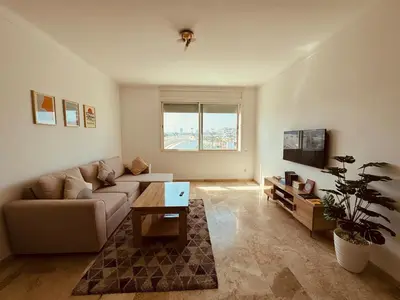a living room with a couch and a table at Atlantica in Rabat