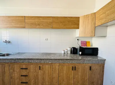 a kitchen with wooden cabinets and a counter top at Atlantica in Rabat
