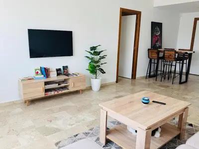 a living room with a tv and a coffee table at Atlantica in Rabat