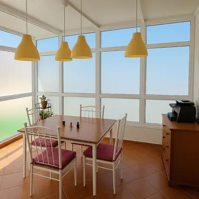 a dining room with a table and chairs and windows at Ideal apartment for business trips in Casablanca