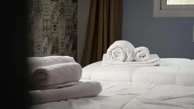 a pile of towels sitting on top of a bed at Yaqcha Home in Casablanca