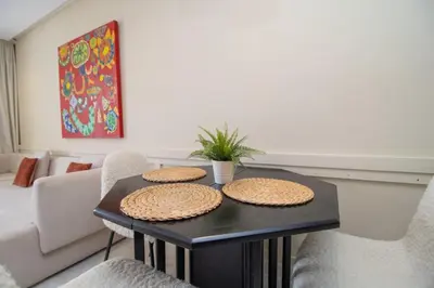 a table in a living room with three straw hats on it at Beautiful Studio in Oasis - Gym access & Balcony & Free Parking & Wifi Fiber in Casablanca