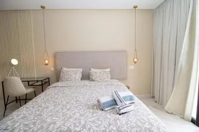 a bedroom with a large bed with two towels on it at Beautiful Studio in Oasis - Gym access & Balcony & Free Parking & Wifi Fiber in Casablanca