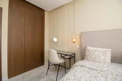 a bedroom with a bed and a chair and a desk at Beautiful Studio in Oasis - Gym access & Balcony & Free Parking & Wifi Fiber in Casablanca