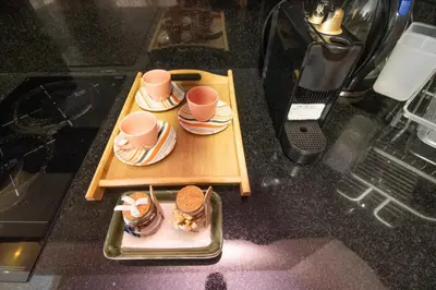 a table with two cups and a plate of food at Elegant Studio in Maarif - Gym access & Free Parking & Wifi Fiber in Casablanca