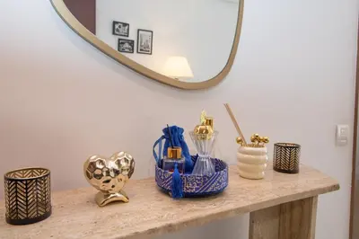 a table with a mirror and some vases on it at Elegant Studio in Maarif - Gym access & Free Parking & Wifi Fiber in Casablanca
