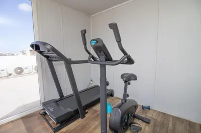 a gym with a treadmill in a room at Elegant Studio in Maarif - Gym access & Free Parking & Wifi Fiber in Casablanca