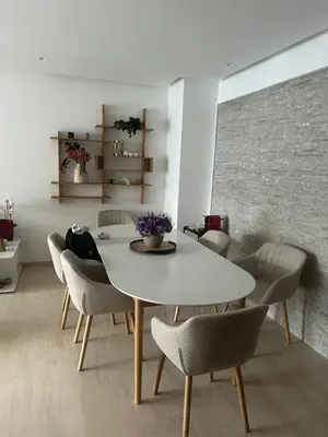 a dining room with a white table and chairs at My Cosy Place Luxury 2BR Apartment CasaFinanceCity in Casablanca