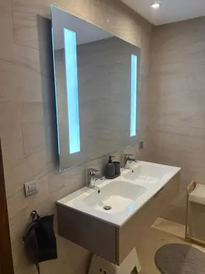 a bathroom with a sink and a large mirror at My Cosy Place Luxury 2BR Apartment CasaFinanceCity in Casablanca